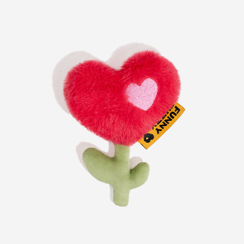 Floral-shaped plush toy with a red heart and green stem.
